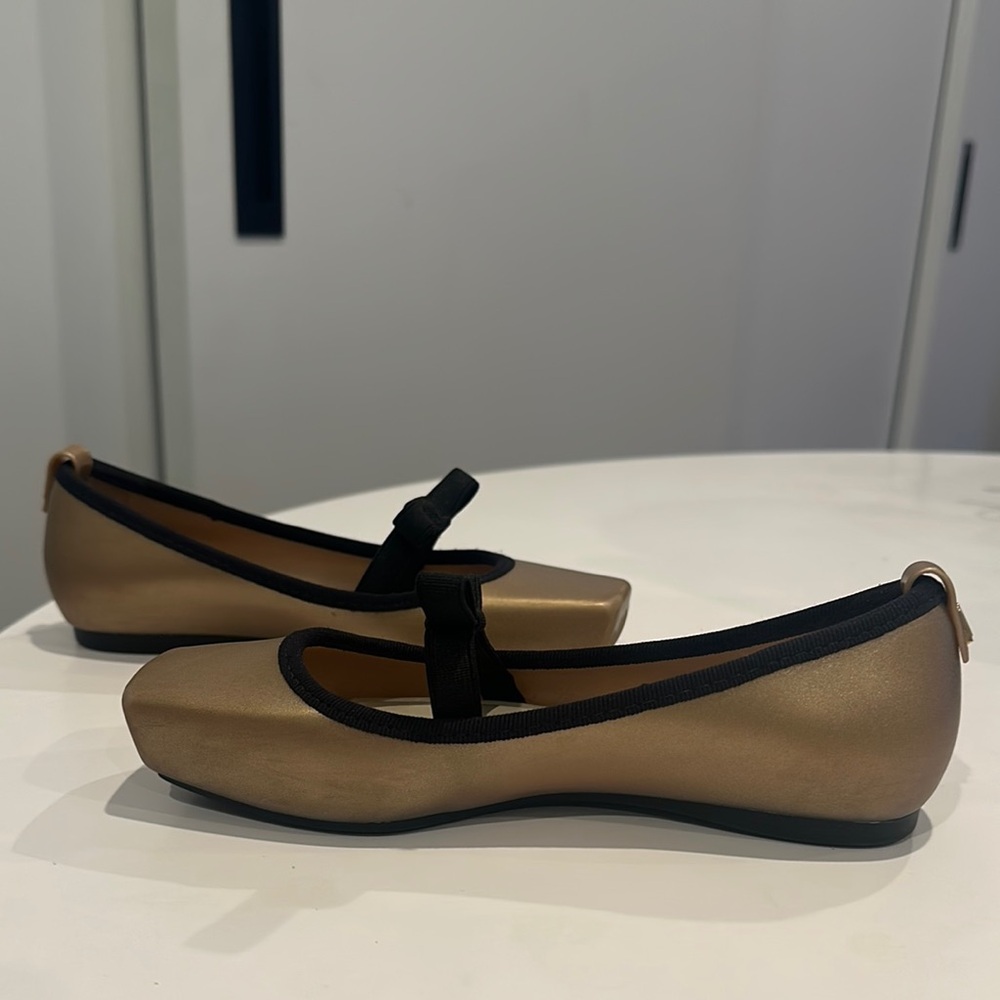 Chic Melissa Gold Ballet Flats with Black Bow and Trim